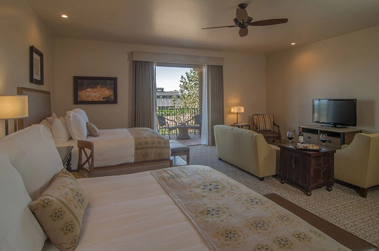 queen junior suite with seating area and tv