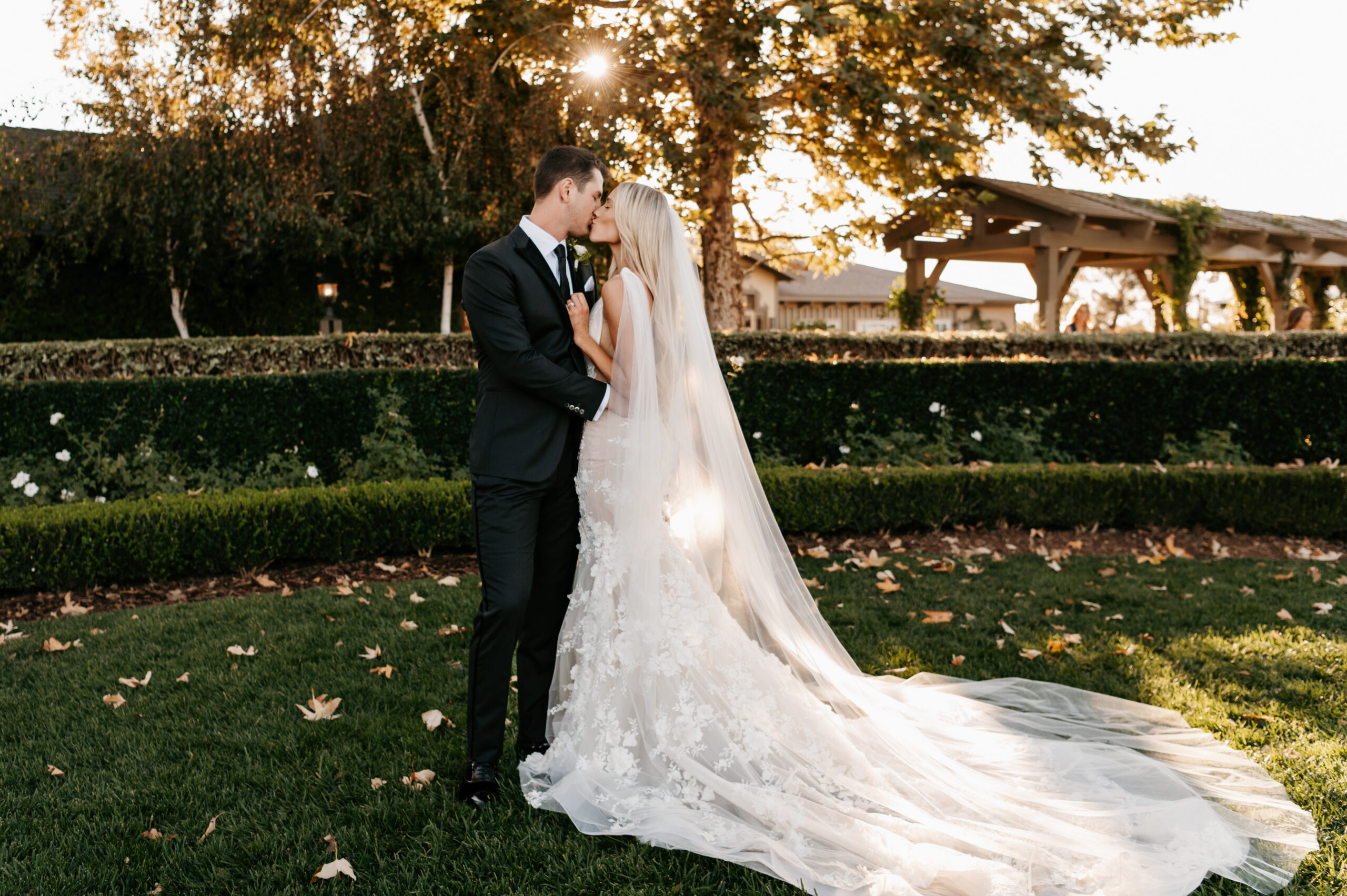 wedding couple kissing on the lawn during golden hour/sunset