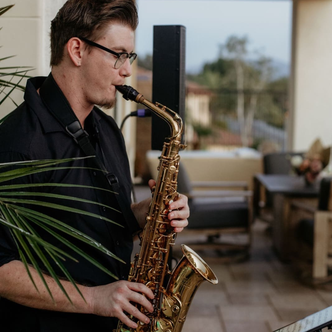 Musician posing with their saxophone for a photo