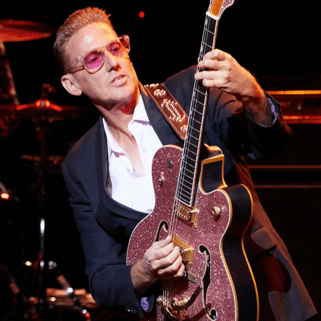 Musician posing with their guitar for a photo