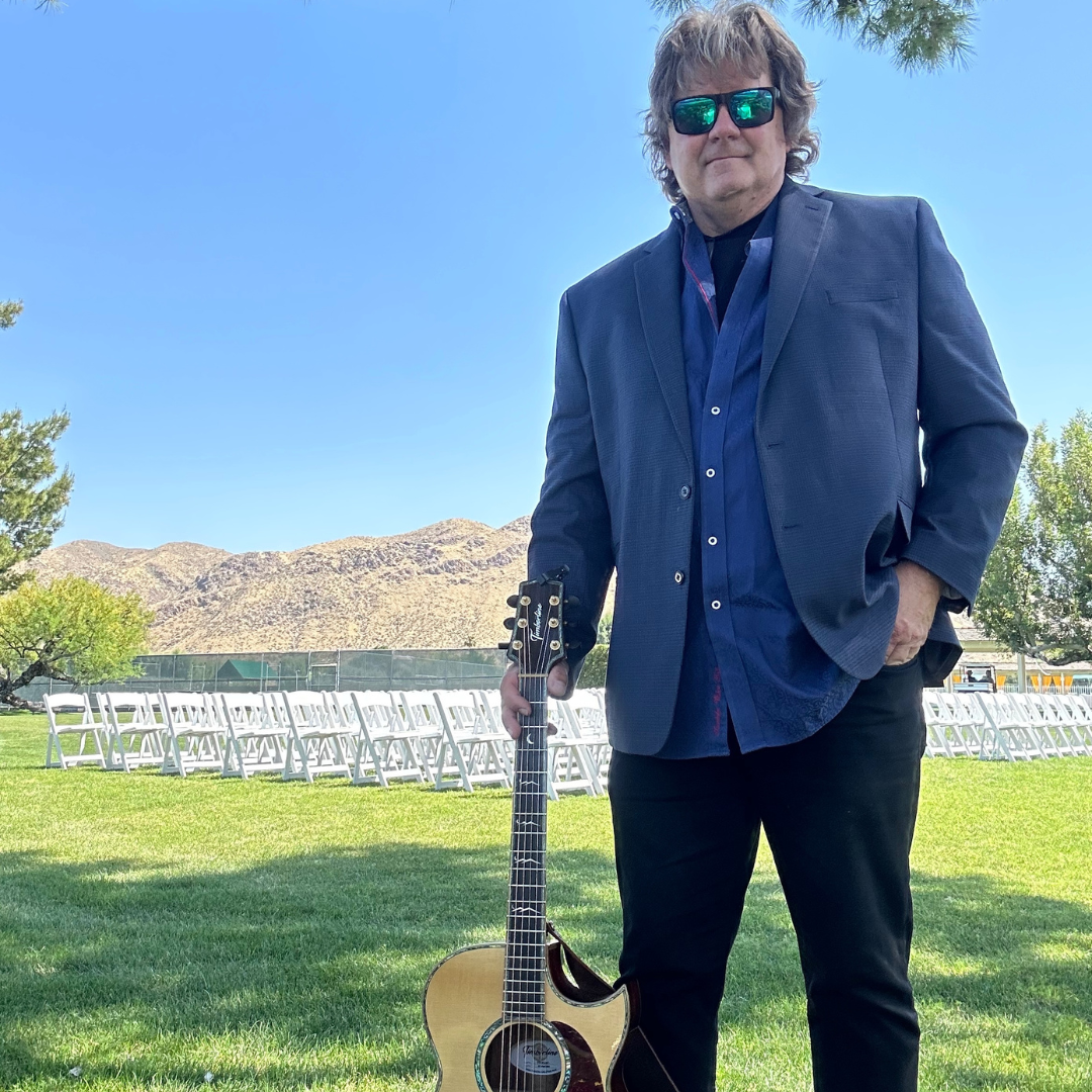 Musician posing with their guitar for a photo