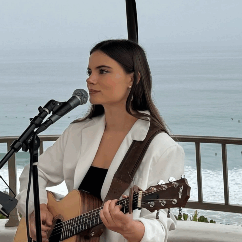 Cassidy Page, music artist signing at a mic playing guitar