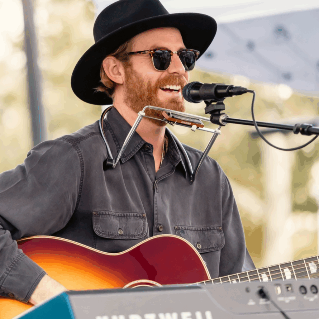 Travis G singing and playing guitar