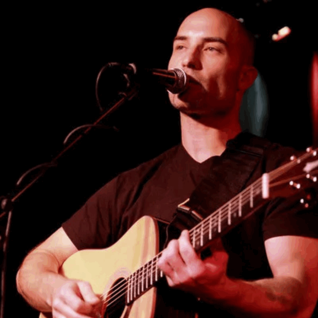 Michael LeClerc singing and playing guitar