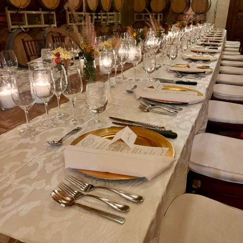 Dinner seating with menus, glasses, and chairs