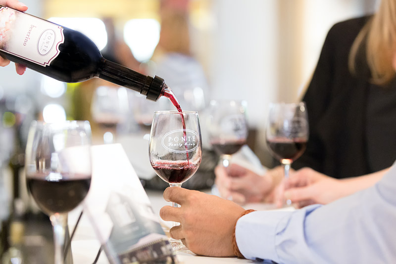 Red wine pouring into a glass in the tasting room