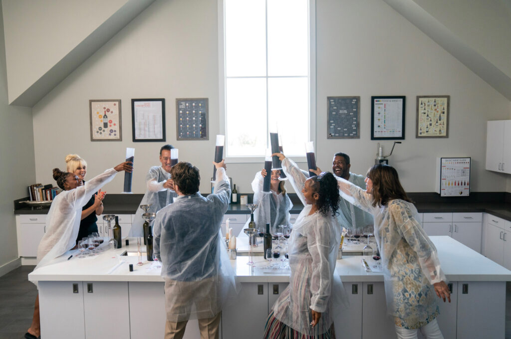 The Bottaia Lab, with people cheersing their wine tubes