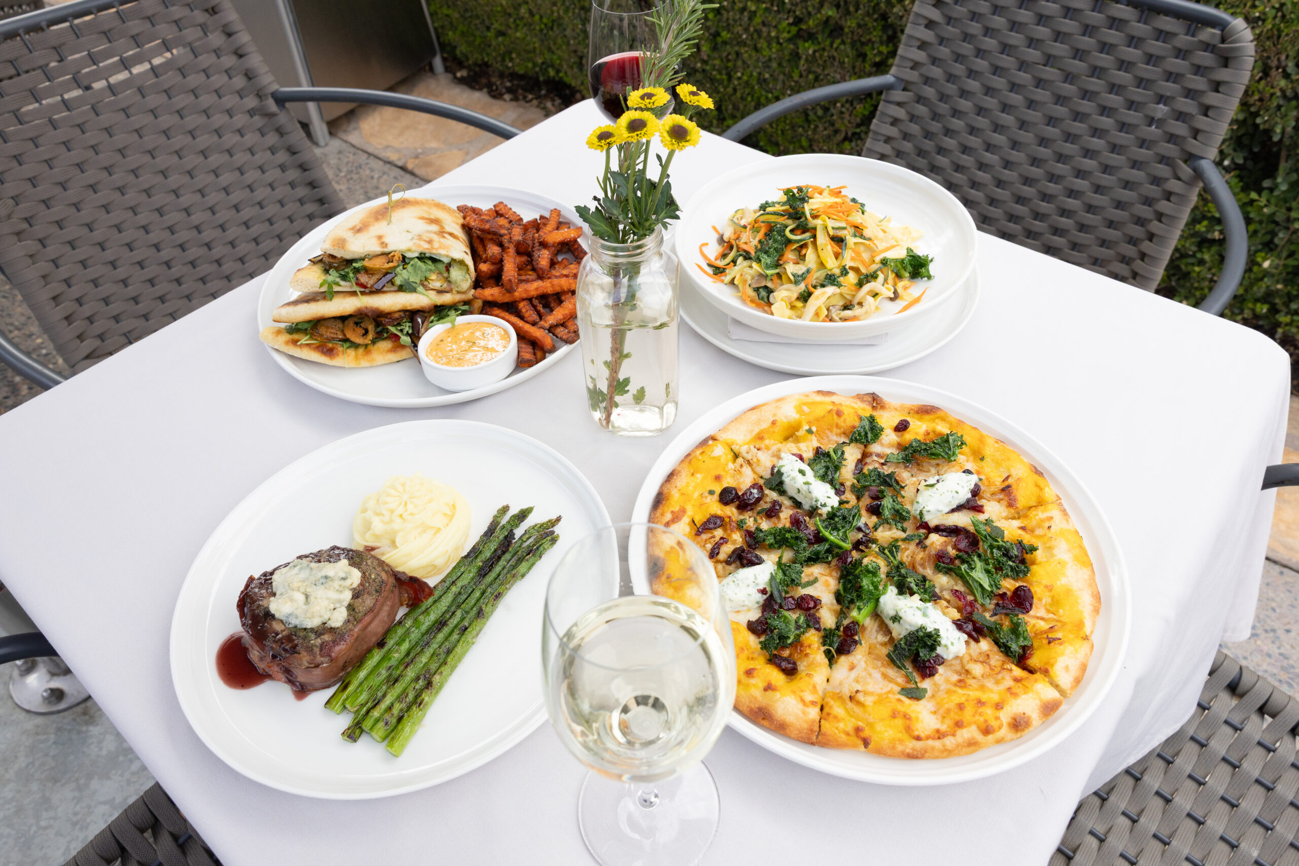 4 Plates with White Wine On a Table At The Restaurant