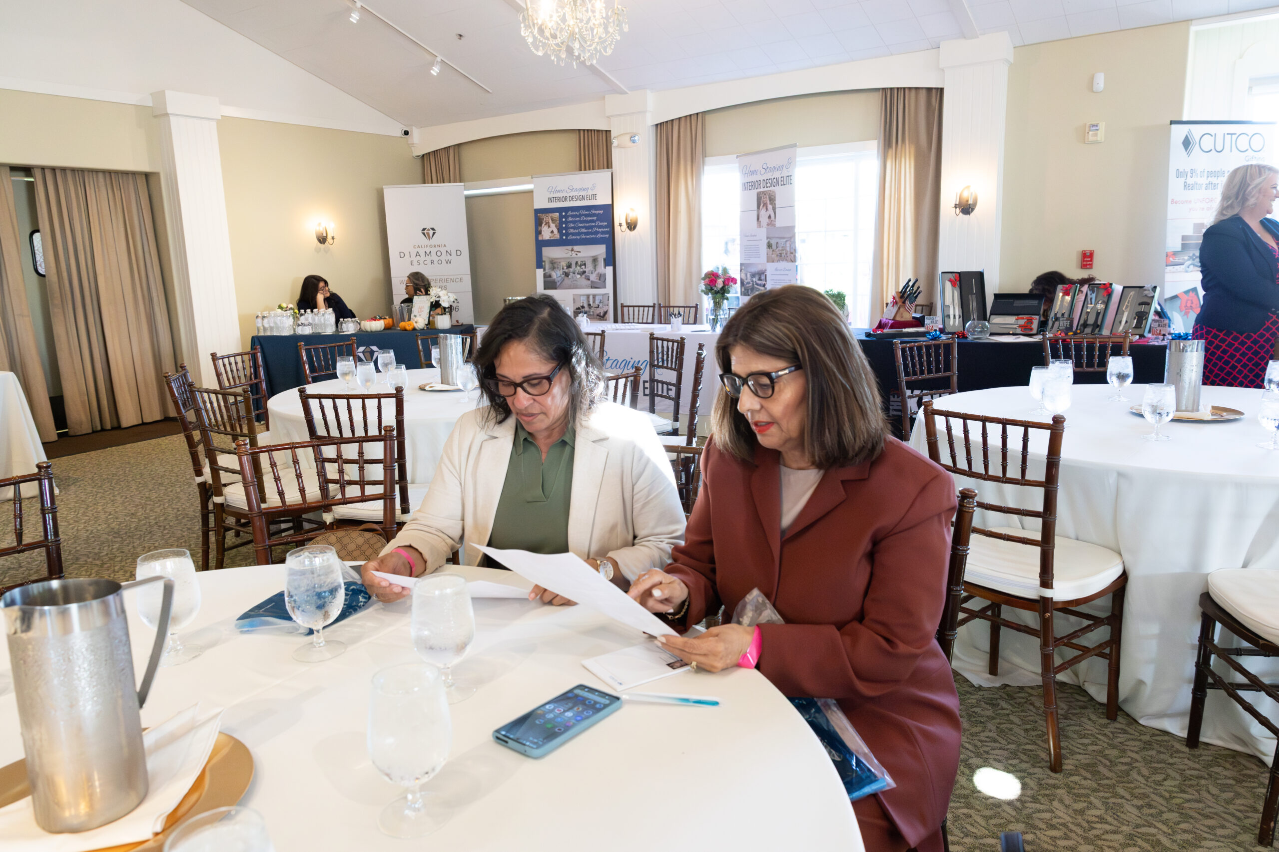 two men reading a paper at a business meeting