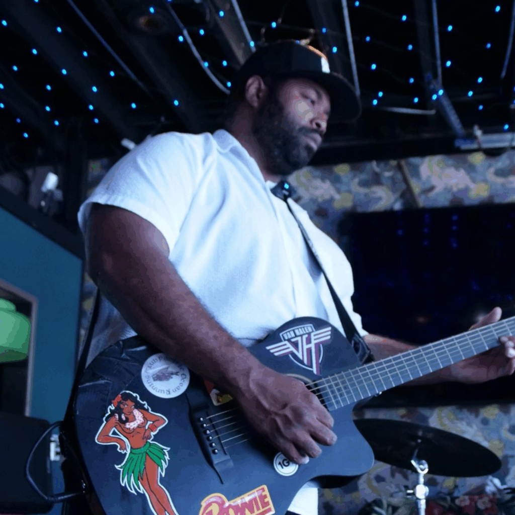 Linwood Polk, musician, who has a black guitar in hand